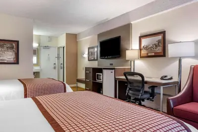a hotel room with two beds and a desk with a computer at Best Western Plus Thousand Oaks Inn in Thousand Oaks