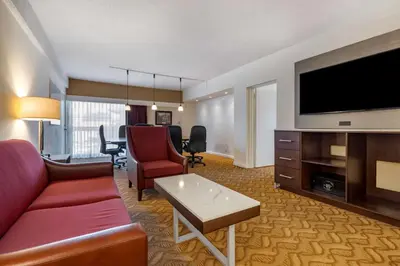 a living room with a couch and a flat screen tv at Best Western Plus Thousand Oaks Inn in Thousand Oaks