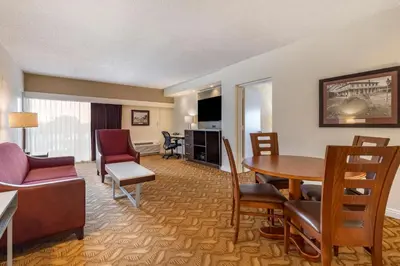 a hotel room with a table and chairs and a living room at Best Western Plus Thousand Oaks Inn in Thousand Oaks