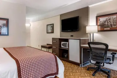a hotel room with a bed and a desk with a computer at Best Western Plus Thousand Oaks Inn in Thousand Oaks
