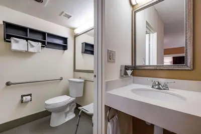 a bathroom with a toilet and a sink and a mirror at Best Western Plus Thousand Oaks Inn in Thousand Oaks