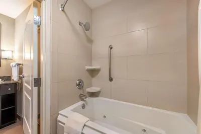 a white bathroom with a tub and a shower at Homewood Suites by Hilton Oxnard/Camarillo in Oxnard