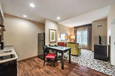 a living room with a table and a refrigerator at Homewood Suites by Hilton Oxnard/Camarillo in Oxnard