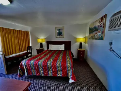 a hotel room with a bed and a desk at Desert Inn in Mojave