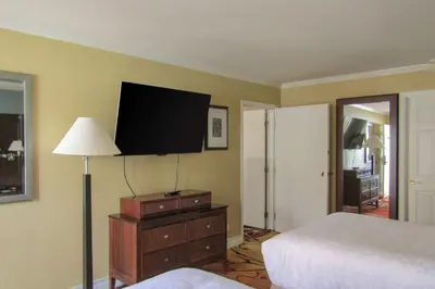 a bedroom with a bed and a flat screen tv at Clarion Inn Near China Lake Naval Station in Ridgecrest
