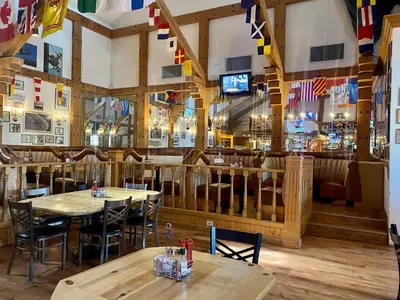 a restaurant with tables and chairs and a bar at Clarion Inn Near China Lake Naval Station in Ridgecrest