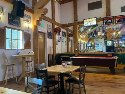 a restaurant with a table and a pool table at Clarion Inn Near China Lake Naval Station in Ridgecrest