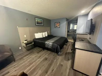 a bedroom with a bed and a television in it at Orange Tustin Inn in Orange in Orange