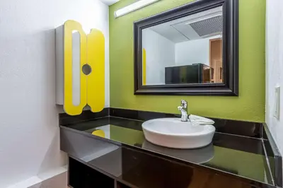 a bathroom with a sink and a mirror at Studio 6-Buttonwillow, CA in Buttonwillow
