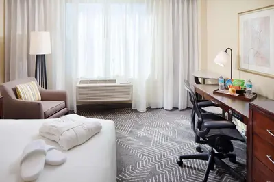 a hotel room with a bed and a desk and a desk at DoubleTree by Hilton Los Angeles/Commerce in Commerce