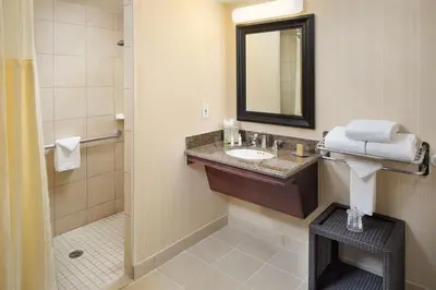 a bathroom with a sink and a mirror at DoubleTree by Hilton Los Angeles/Commerce in Commerce