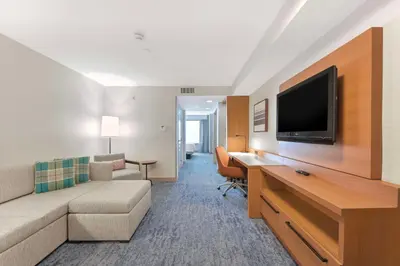 a living room with a couch and a flat screen tv at Hilton Garden Inn LAX - El Segundo in El Segundo