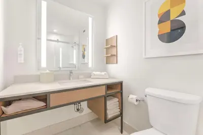 a white bathroom with a sink and a toilet at Hilton Garden Inn LAX - El Segundo in El Segundo