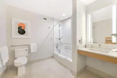 a white bathroom with a toilet and a sink at Hilton Garden Inn LAX - El Segundo in El Segundo