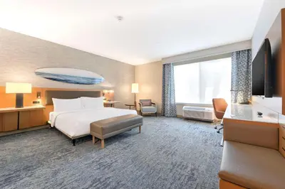 a hotel room with a bed and a flat screen tv at Hilton Garden Inn LAX - El Segundo in El Segundo