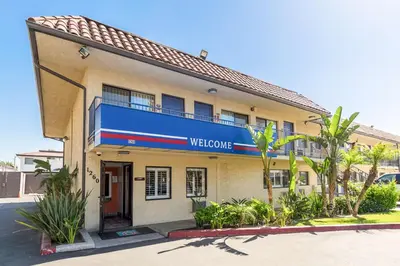 a building with a welcome sign on the side of it at Motel 6 Riverside, CA - UCR East in Riverside