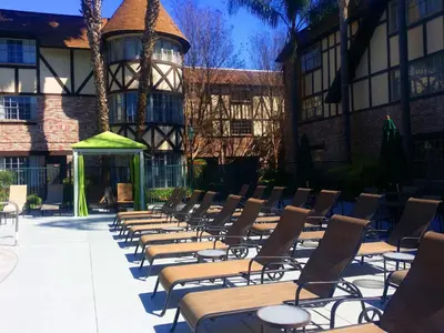 a row of chairs and tables in front of a building at Anaheim Majestic Garden Hotel in Anaheim