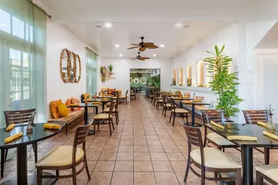 a dining room with tables and chairs at Best Western Plus Hill House in Bakersfield