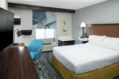 a hotel room with a bed and a desk and a television at Hampton Inn Los Angeles Santa Clarita in Santa Clarita