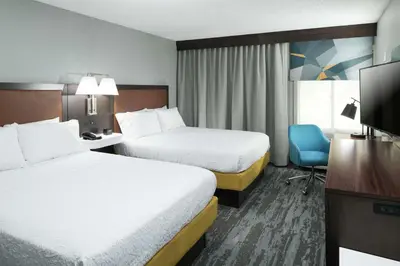 a hotel room with two beds and a flat screen tv at Hampton Inn Los Angeles Santa Clarita in Santa Clarita