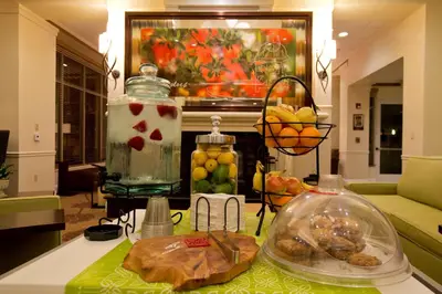 a kitchen with a table with fruit in a room at Hilton Garden Inn Oxnard/Camarillo in Oxnard