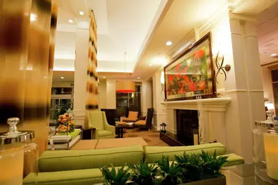 a living room with green furniture and a fireplace at Hilton Garden Inn Oxnard/Camarillo in Oxnard