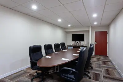 a conference room with a wooden table and black chairs at Hampton Inn Los Angeles/Arcadia in Arcadia