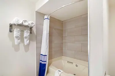a bathroom with a tub and a toilet at Best Western Posada Royale Hotel & Suites in Simi Valley
