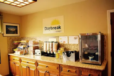 a kitchen counter with a dry erase sign on the wall at Days Inn by Wyndham Anaheim Near the Park in Anaheim