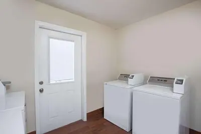 a room with two washer and dryers and a door at Days Inn by Wyndham Anaheim Near the Park in Anaheim