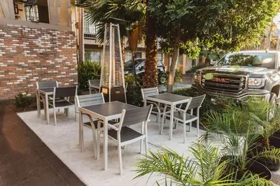 a group of tables and chairs in front of a car at Best Western Palm Garden Inn in Westminster