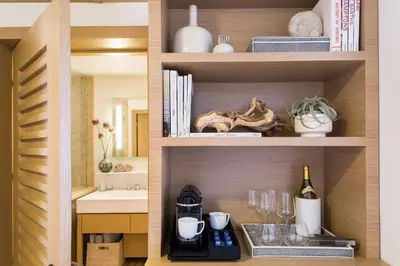 a shelf with a bottle of wine and a sink at Malibu Beach Inn in Malibu