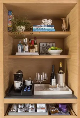 a cupboard with alcohol and wine glasses on it at Malibu Beach Inn in Malibu