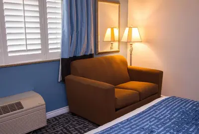a room with a chair in a hotel room at Regency Inn in Los Angeles in Los Angeles