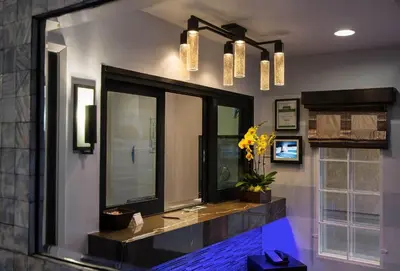 a bathroom with a large mirror and a window at Regency Inn in Los Angeles in Los Angeles