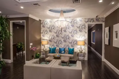 a living room with a couch and a chandelier at Hilton Los Angeles/San Gabriel in San Gabriel