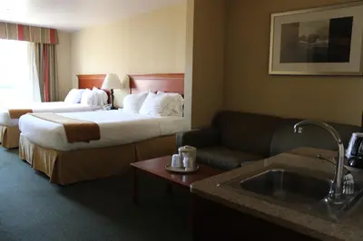 a hotel room with a bed and a couch at Holiday Inn Express Tehachapi by IHG in Tehachapi