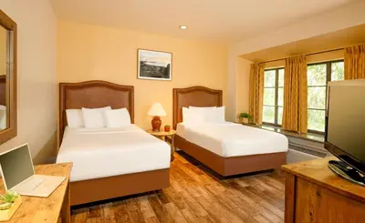 a hotel room with two beds and a television at Clocktower Inn Ventura in Ventura