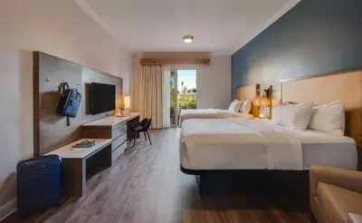 a hotel room with two beds and a television at Ayres Hotel Chino Hills Ontario in Chino Hills