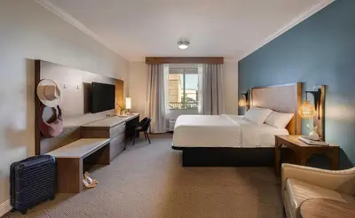 a hotel room with a bed and a desk at Ayres Hotel Chino Hills Ontario in Chino Hills