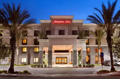 a hotel with a sign on the front of it at Hampton Inn Los Angeles Orange County Cypress in Cypress