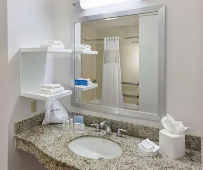 a bathroom with a sink and a mirror at Hampton Inn Los Angeles Orange County Cypress in Cypress