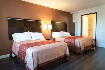 a hotel room with two beds in a room at Maywood Inn in Maywood