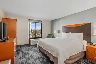 a hotel room with a large bed and a television at Fairfield Inn & Suites Anaheim North Buena Park in Buena Park