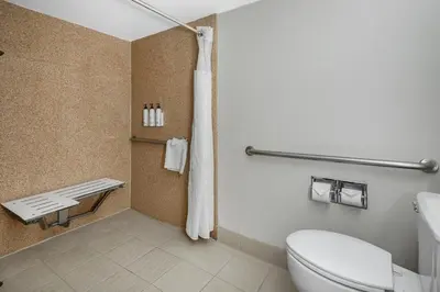 a bathroom with a white toilet and a shower at Fairfield Inn & Suites Anaheim North Buena Park in Buena Park