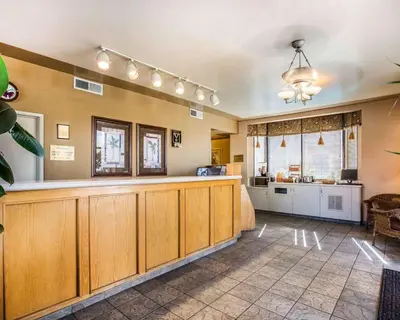 a large room with a bar and a kitchen at California Inn and Suites Bakersfield in Bakersfield
