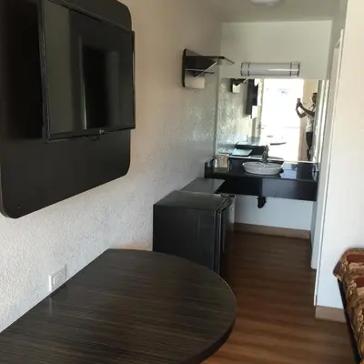 a small kitchen with a sink and a table in a room at Motel 6 Bakersfield in Bakersfield