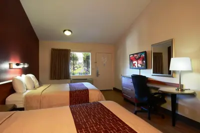 a hotel room with two beds and a desk at Red Roof Inn San Dimas - Fairplex in San Dimas