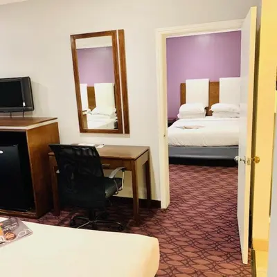 a hotel room with a desk and a mirror at Hotel Pacific, Manhattan Beach in Manhattan Beach