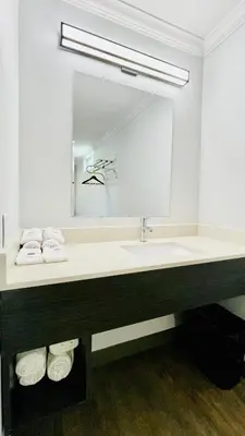 a bathroom with a sink and a large mirror at Motel 6 Pico Rivera - Los Angeles, CA in Pico Rivera